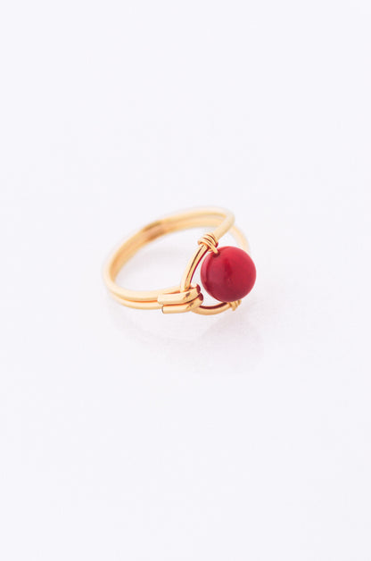 Sustainable Gold ring with a red coral on a white background