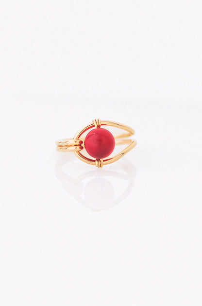 Sustainable Gold ring with a red coral on a white background